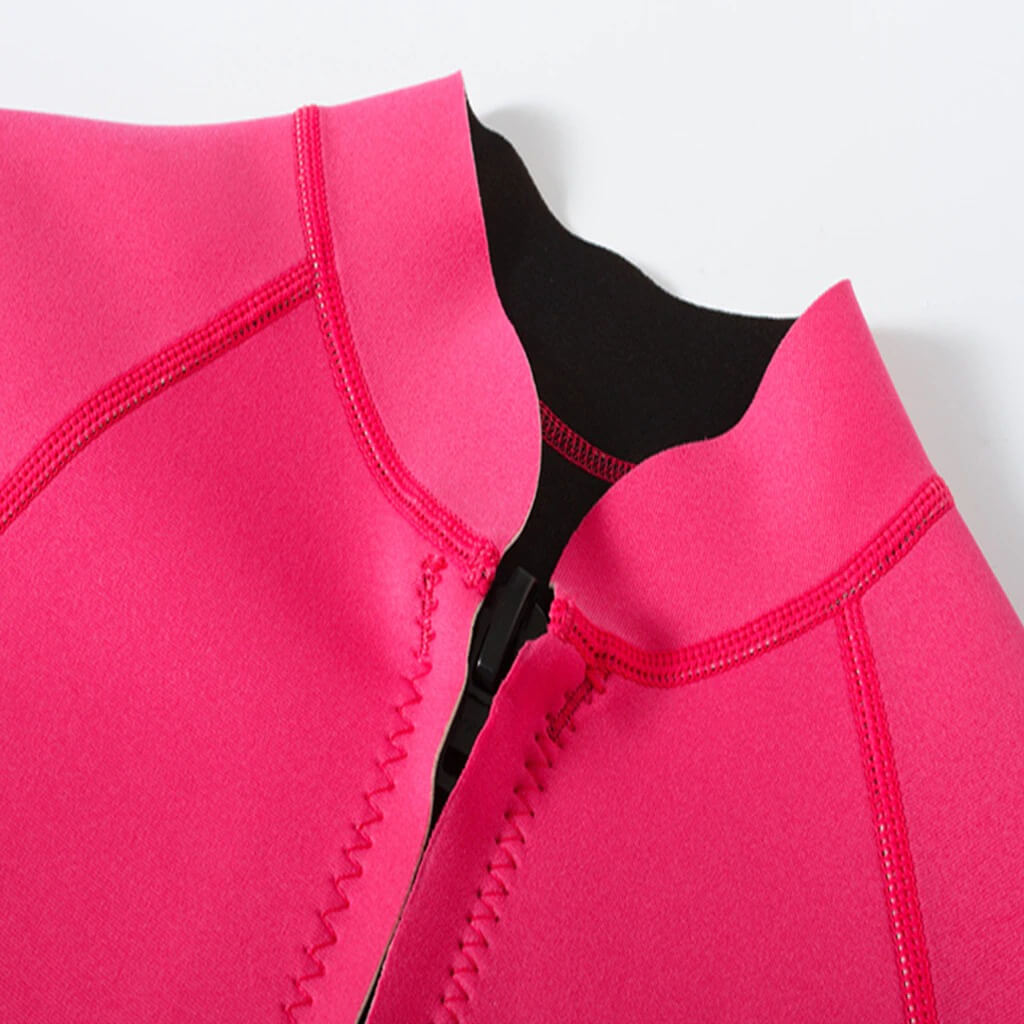 Close-up of pink women's rashguard with zipper, 2mm thick, designed for deep-diving surfing, showcasing stitching detail for durability.