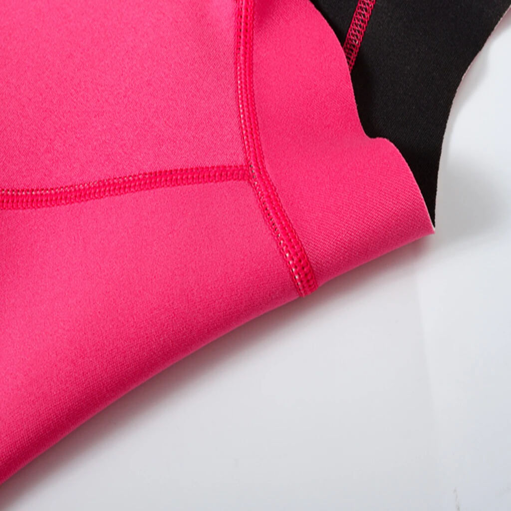 Close-up of pink microfiber women's rashguard for deep-diving surfing, showcasing durable stitching and soft fabric.
