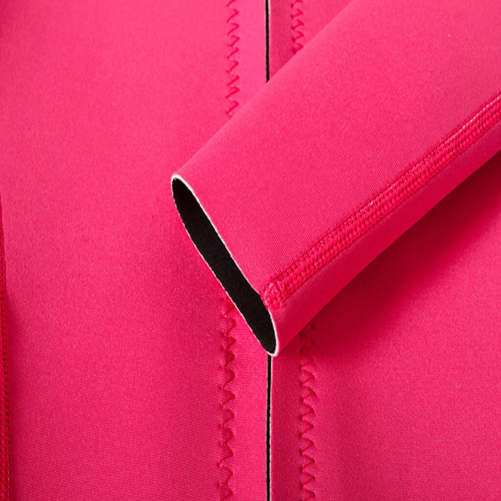 Close-up of pink women's rashguard seam and sleeve, designed for deep-diving and surfing, offering comfort and durability for watersports.