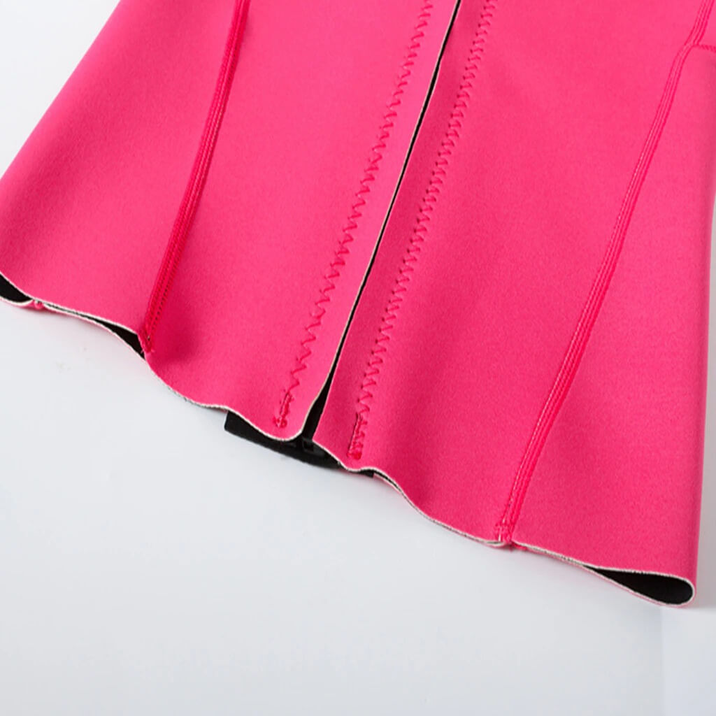 Close-up of pink stitching detail on women's rashguard, designed for deep-diving surfing, made with durable microfiber material.
