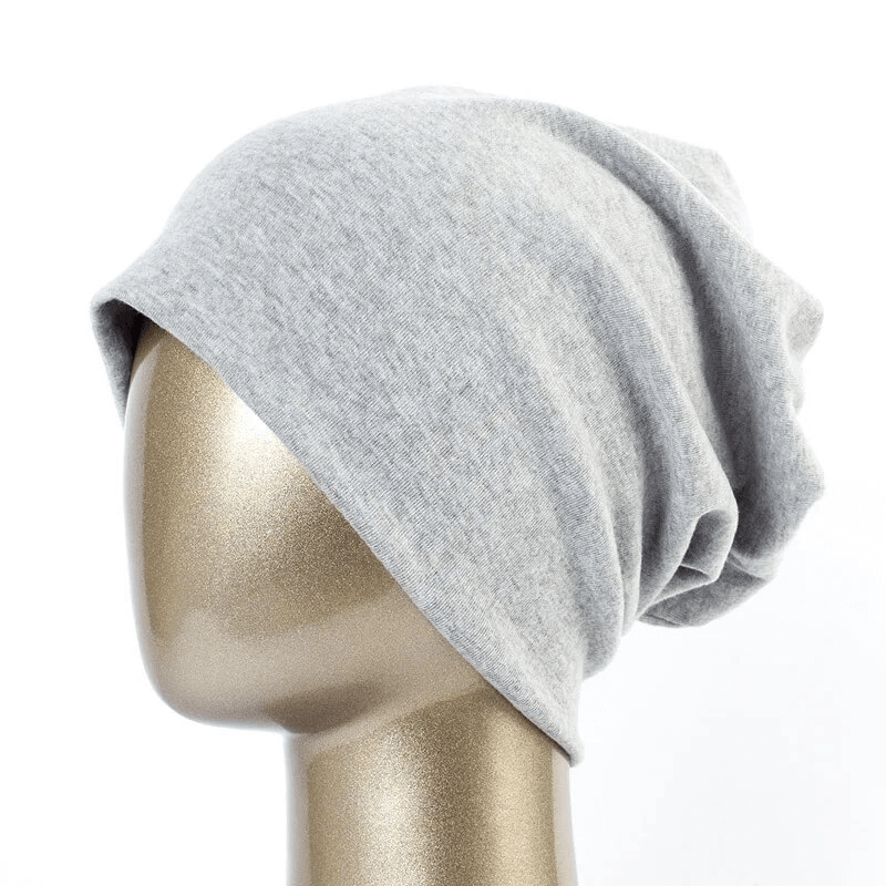 Fashionable cotton casual women's beanie in solid gray, perfect for warmth and style, crafted with cotton and polyester.