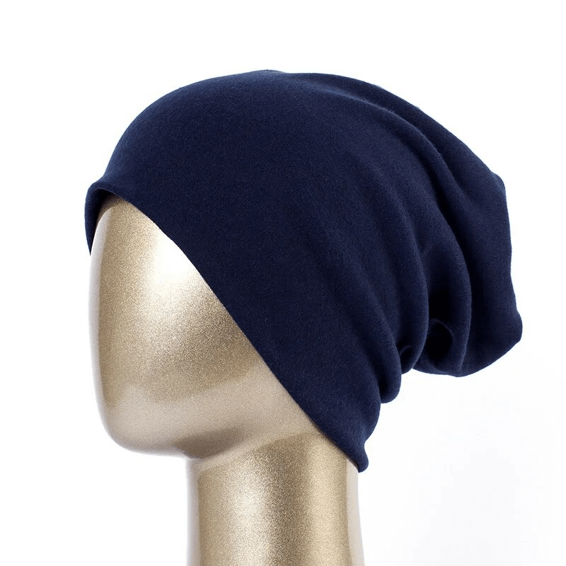 Fashionable cotton casual women's beanie in dark blue on a mannequin, perfect for adding style and warmth to any outfit.