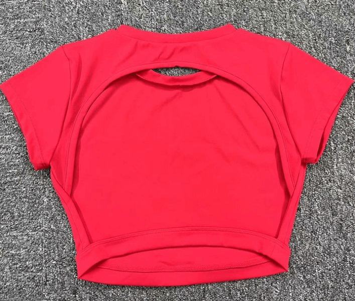 Red cropped open back top with short sleeves, perfect for yoga. Made of quick-drying nylon with stylish elastic design. Model SF1370.
