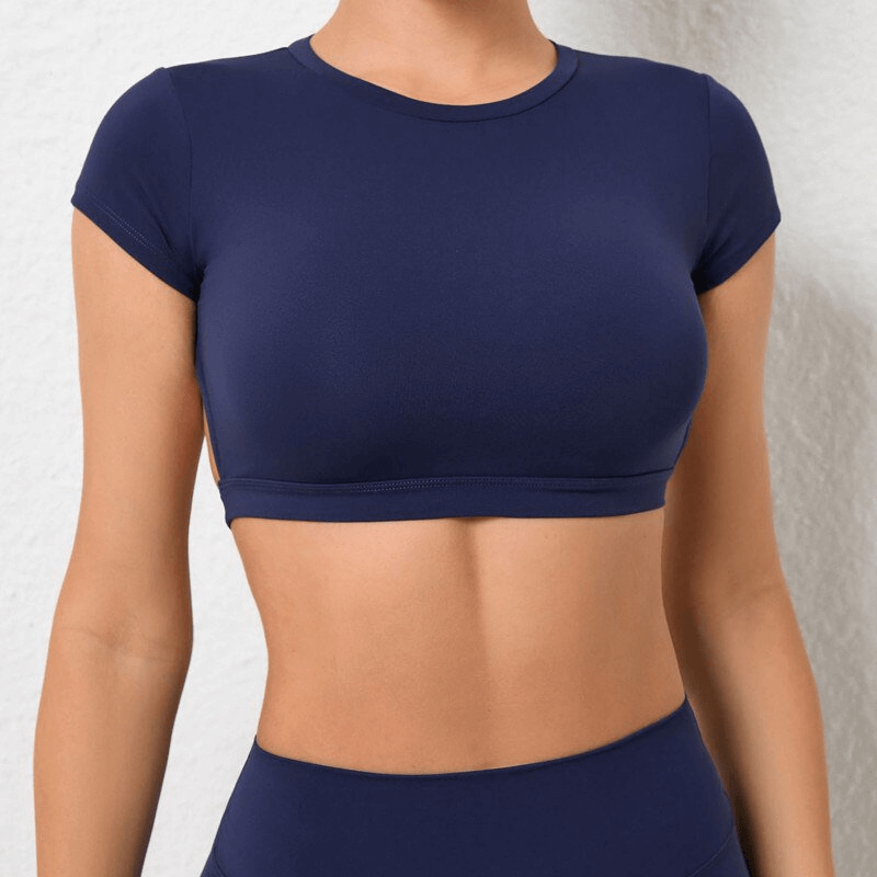Fashionable navy elastic cropped women's open back top for yoga, featuring quick-drying nylon and short sleeves for breathability.
