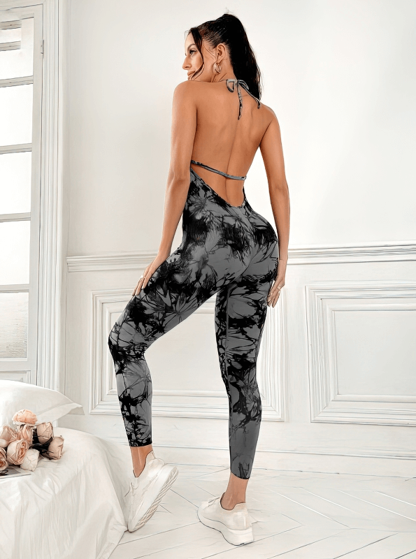 Fashionable elastic sports jumpsuit with open back for women, perfect for yoga, in a stylish print. Breathable nylon material.