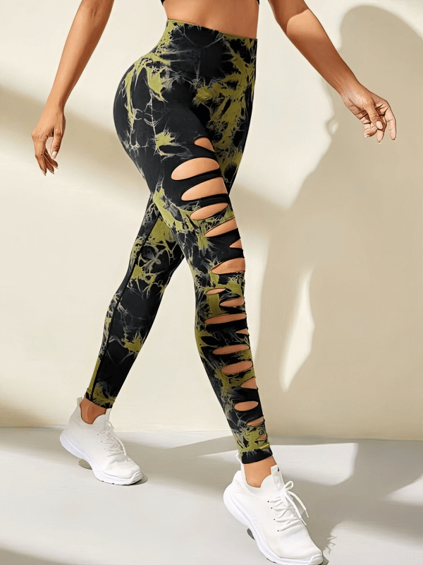 Fashionable elastic tight women's leggings with stylish cutouts, high-waisted fit, in black and green design, perfect for active wear.