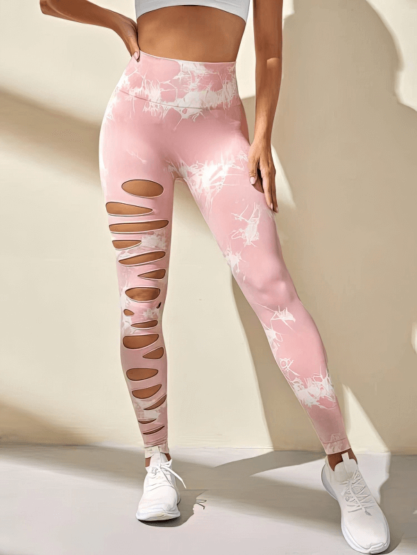Woman wearing pink high-waisted leggings with stylish cutouts, showcasing Fashionable Elastic Tight Women's Leggings - SF1310.
