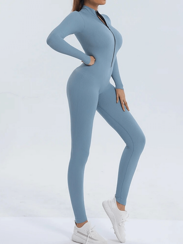 Woman wearing blue seamless zip-up bodycon jumpsuit for training, showcasing flexibility and comfort for yoga and workouts.