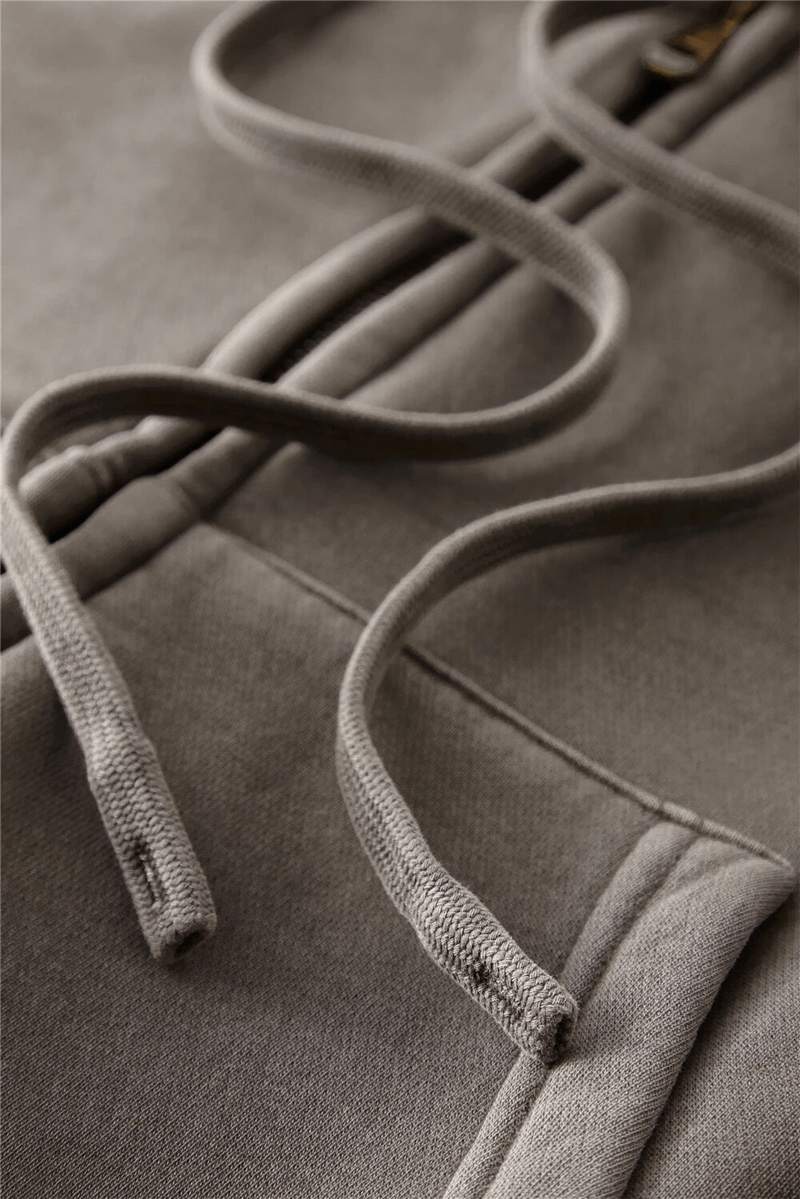 Close-up of stylish fleece short women's hoodie with zipper detailing, showcasing thick fleece material and drawstrings.