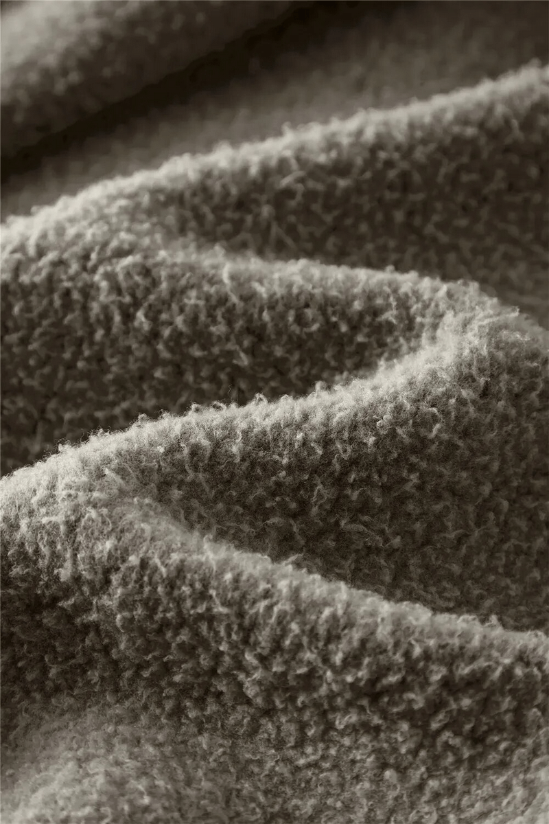 Close-up of soft, textured fleece fabric in gray, showcasing the thick, warm material used in the SF1672 Women's Hoodie.