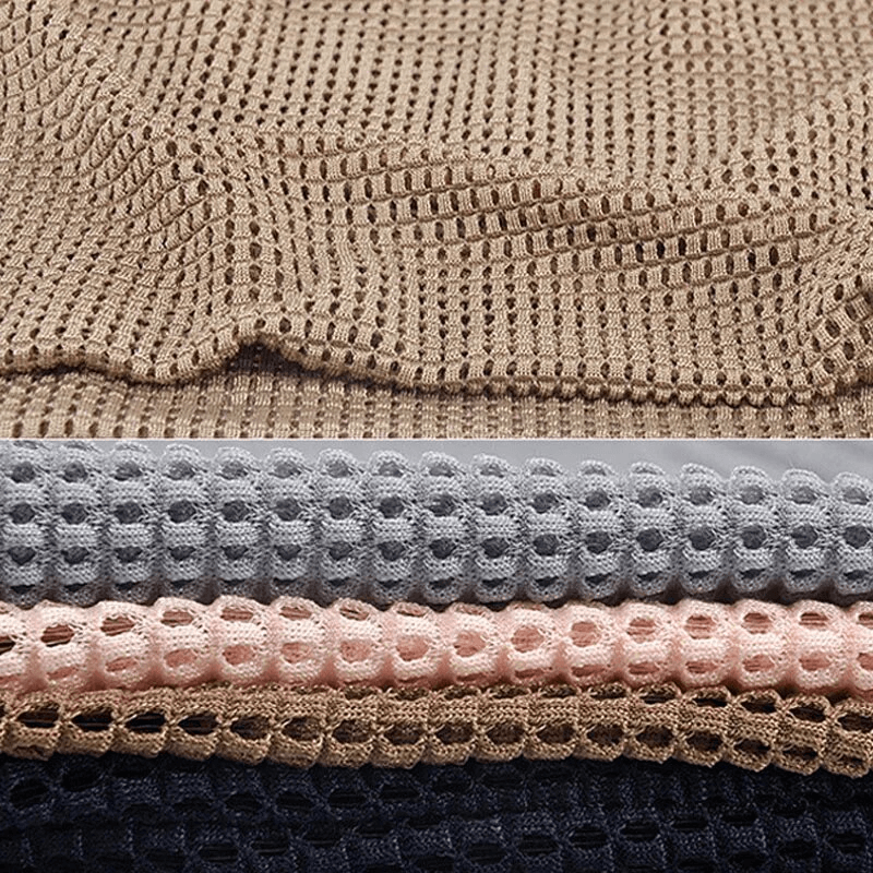 Stack of fashionable lightweight mesh unisex beanies in various colors, made of breathable polyester with quick-dry feature.