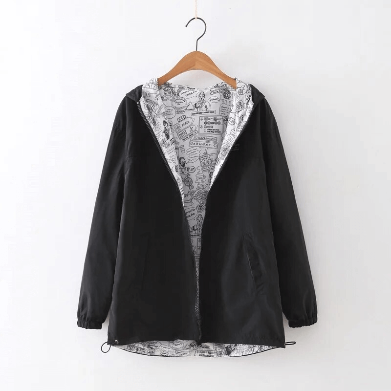 Fashionable two-sided breathable women's windbreaker with hood, wide-waisted black outer layer and patterned inner lining on hanger.