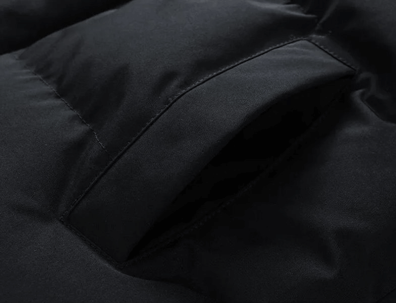 Close-up of a black pocket on a fashionable warm unisex hooded down jacket, showcasing sleek stitching and durable fabric.