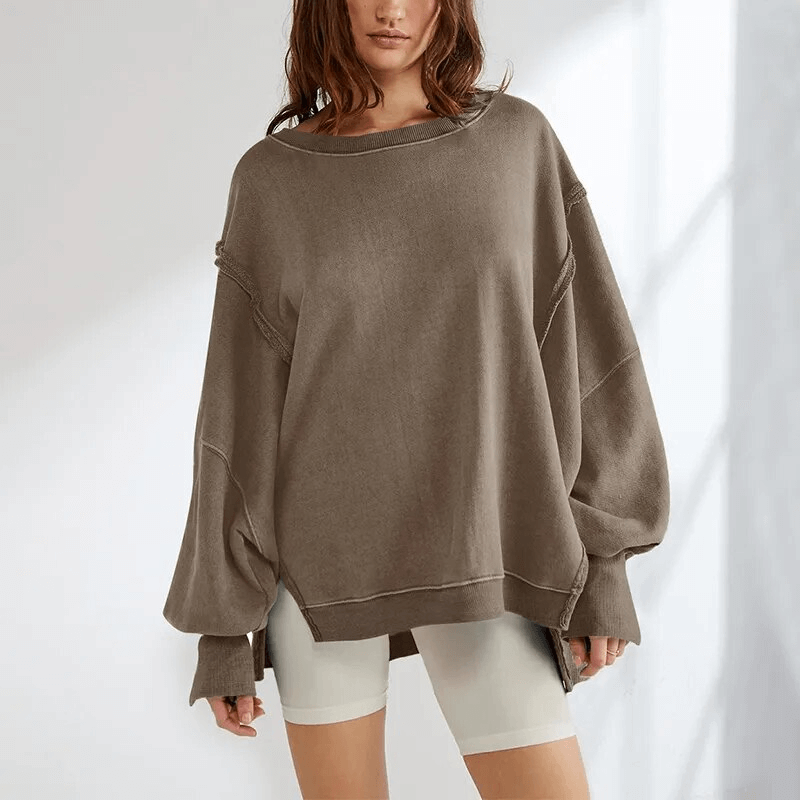 Fashionable women's oversize sweatshirt with reversible seam, O-neck, loose fit, and patchwork decoration, perfect for versatile styling.