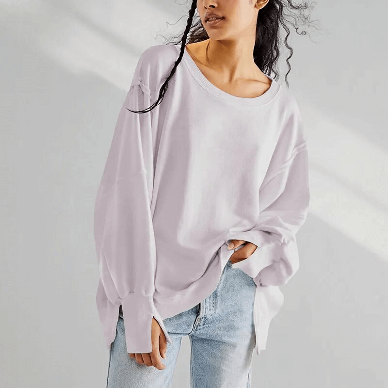Stylish oversized women's sweatshirt with reversible seam and O-neck collar, made from comfy cotton, shown in a relaxed fit.