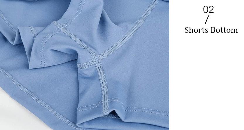 Close-up view of blue shorts bottom with detailed stitching for Feather-Light Tennis Skirt-Shorts, highlighting design and fabric.