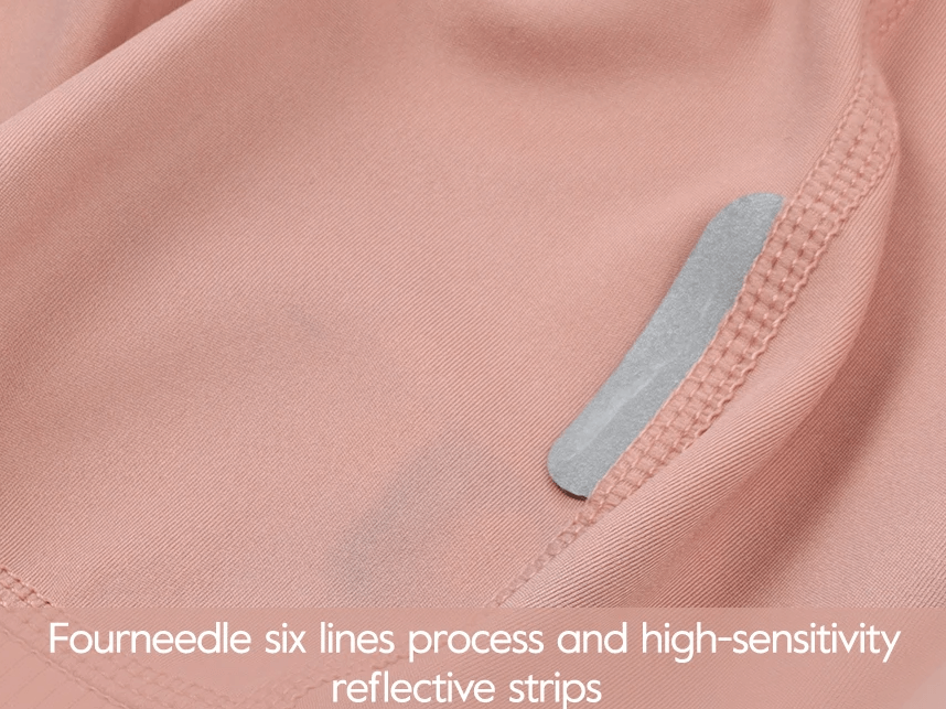 Close-up of pink cycling bib shorts fabric with reflective strip detail, four-needle stitching for durability and high sensitivity.