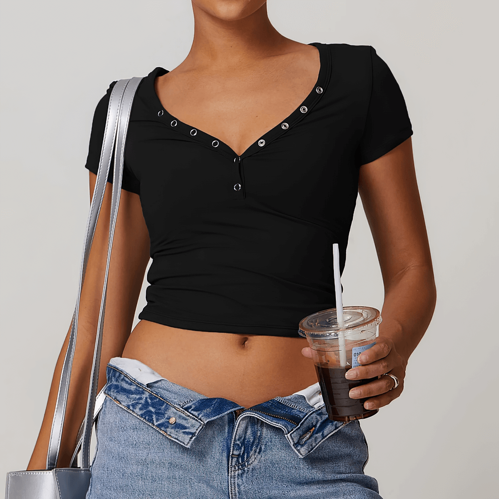 Woman wearing black V-neck button short sleeve yoga T-shirt with a casual outfit, holding iced coffee for an energetic workout day.