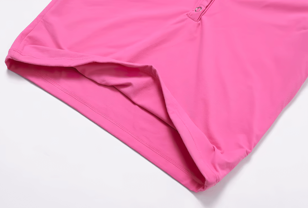 Close-up of a vibrant pink fabric with button details, displaying smooth texture and quality stitching.