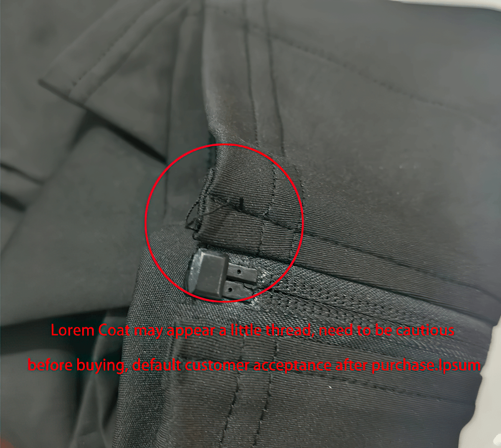 Close-up of black garment with visible stitching and zipper detail.