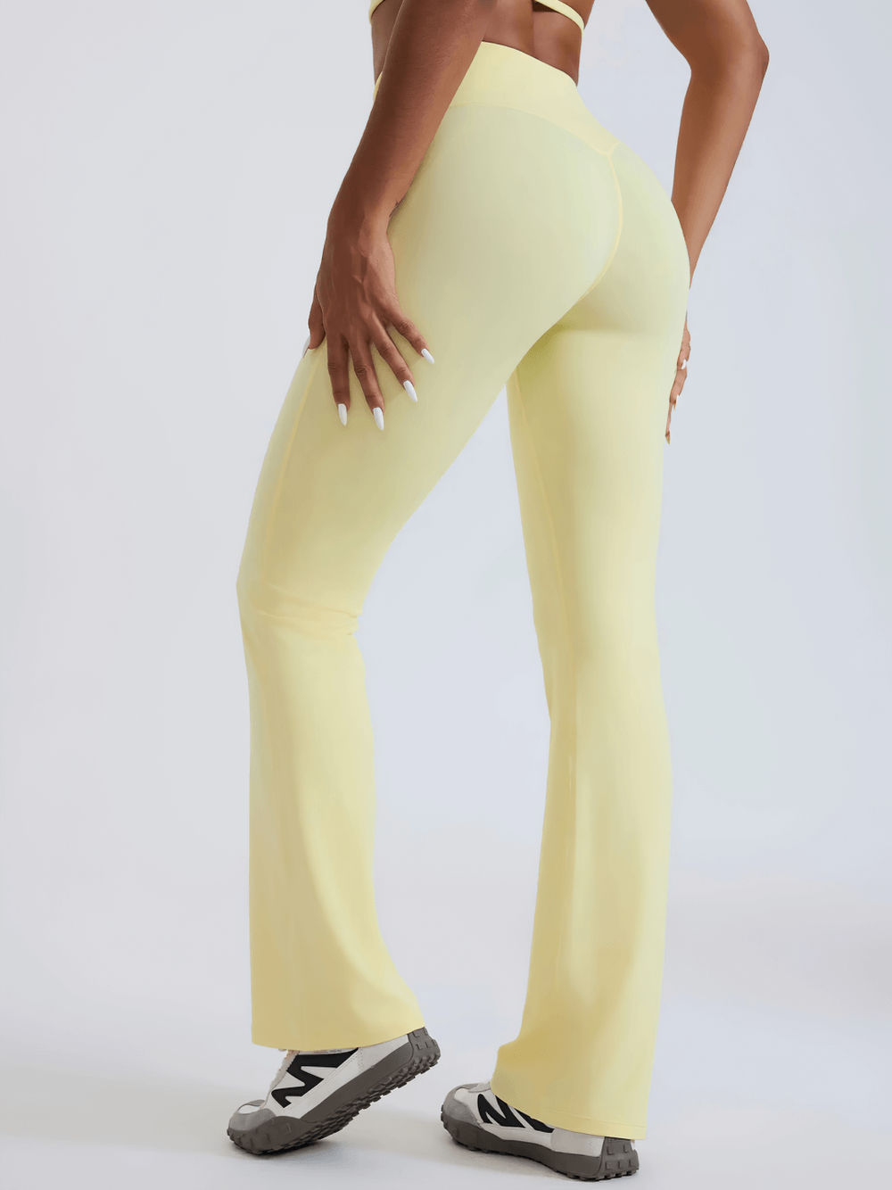 Alt Tag: Female High-Waisted Flared Yoga Pants - SF4286 in pale yellow, full-length flared fit with elastic high waist, back view