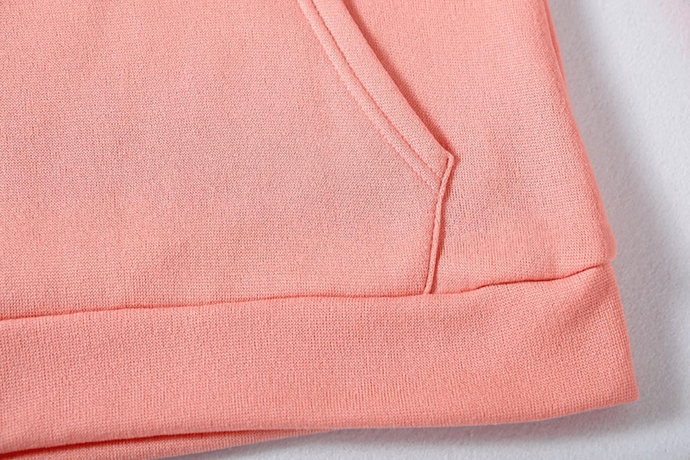 Alt Tag: Female Loose Fit Hooded Pocket Hoodie - SF4522 coral fabric close-up showing front pocket seam and ribbed hem