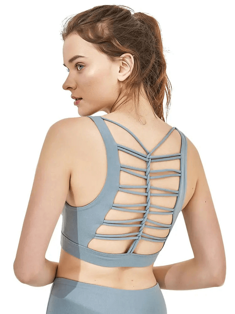 Woman in a backless nylon sports bra for gym workouts, featuring breathable polyamide fabric, anti-pilling, and quick-dry design.