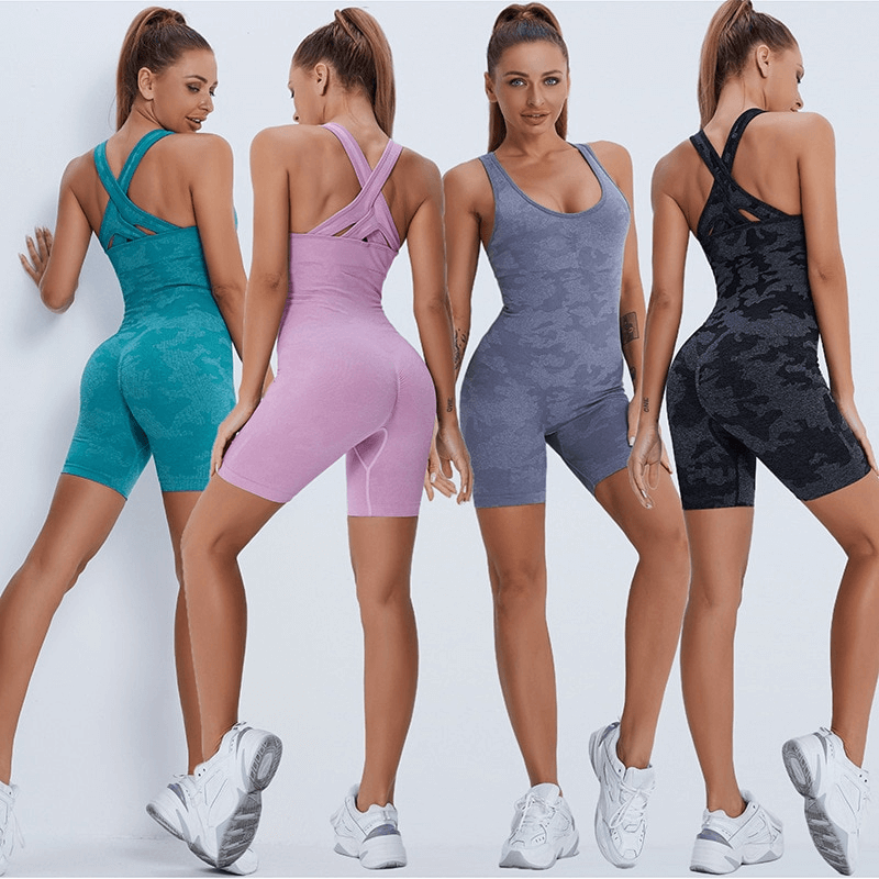 Women wearing colorful sleeveless seamless jumpsuits for workouts, featuring breathable fabric in four stylish colors: teal, pink, grey, and black.