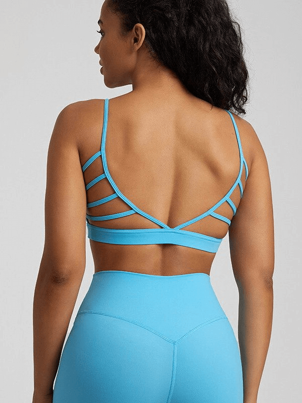 Woman wearing blue open back sports bra, showcasing breathability and style.