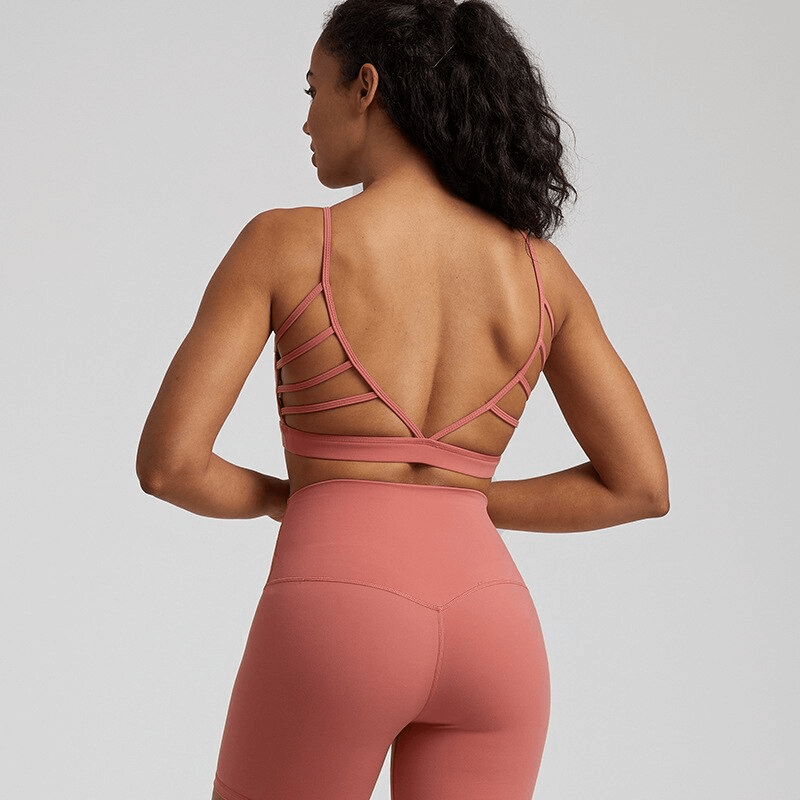 Female wearing open-back sports bra in solid color, perfect for workouts, crafted from stretchy, quick-dry fabric, SF1488 model.
