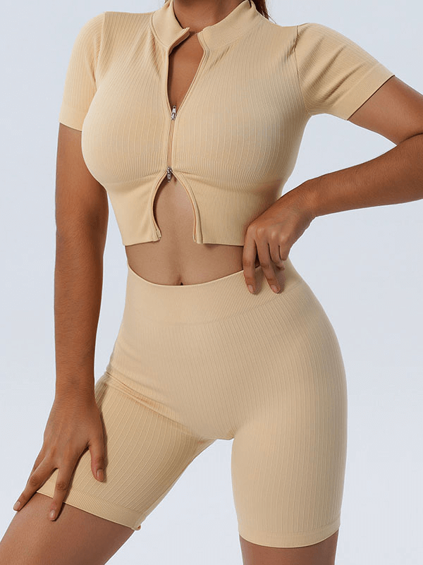 Woman wearing beige seamless sports shorts and crop top, showcasing flexible fabric suitable for yoga and workouts.