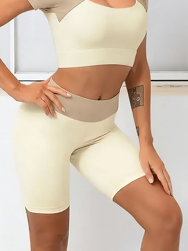 Woman wearing high-waisted two-color sports shorts SF1770, designed for breathability and comfort with spandex and nylon fabric.