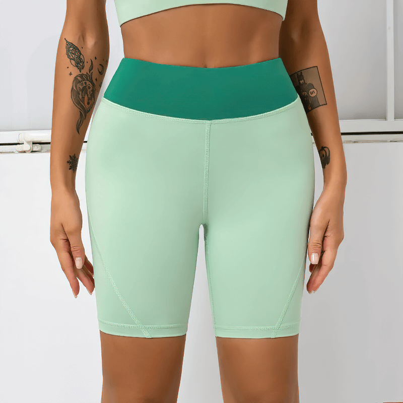 Women's high waist two-color sports shorts in green, offering comfort and breathability for workouts with quick-drying fabric.