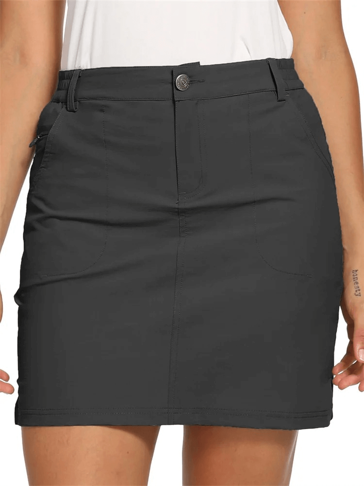 Female sports short skirt with zip pockets in solid color, perfect for tennis, crafted from breathable polyester and spandex.