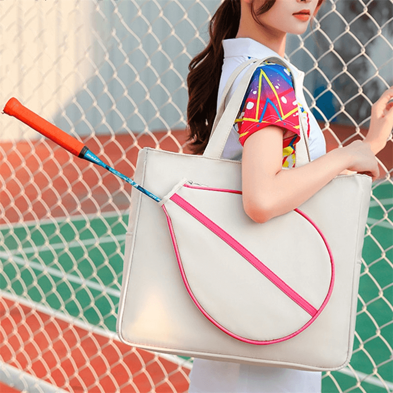 Woman holding stylish sporty bag with tennis racket pocket, ideal for female racket sports players.