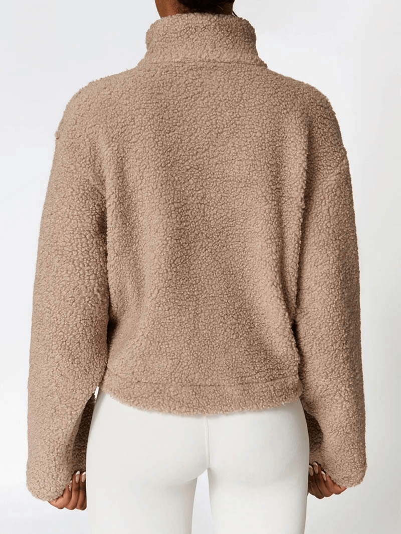 Back view of female wearing a thick, warm fleece jacket with zipper, ideal for winter. Polyester material, solid pattern, classic style. SF1804