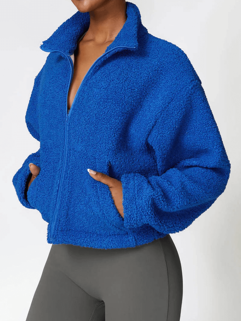 Female wearing blue fleece jacket with zipper, winter-ready and breathable. Thick polyester for warmth. Classic style - SF1804.