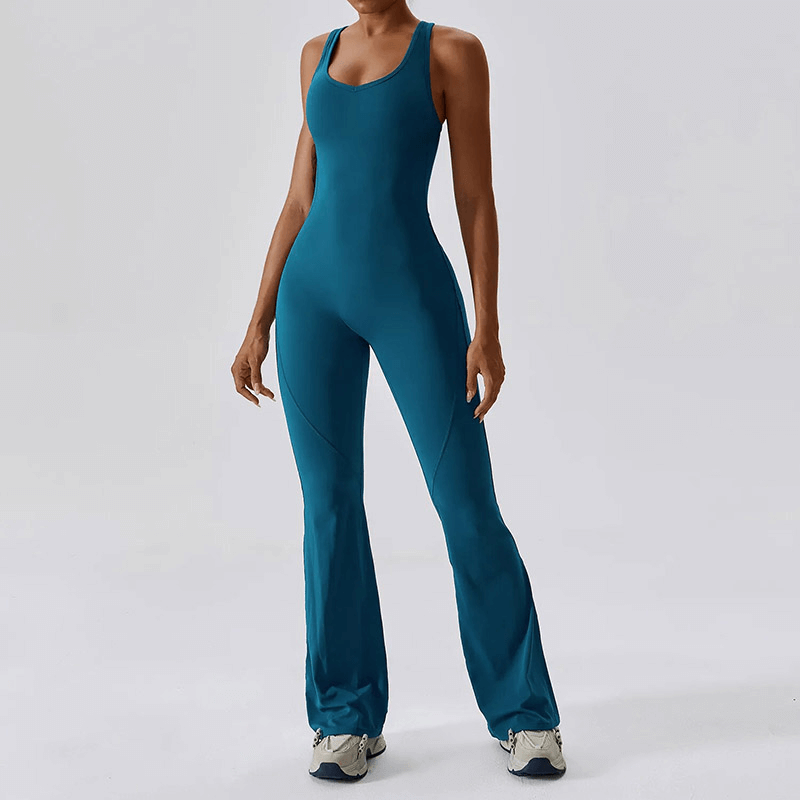 Woman wearing a blue fitness open back compressed jumpsuit, ideal for yoga, running, and gym workouts.