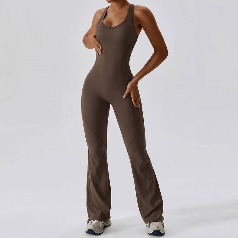 Woman wearing a fitness open back compressed jumpsuit, ideal for yoga and running, showcasing breathable design and range of motion.