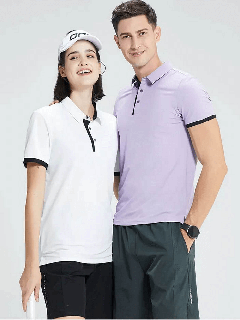 Man in violet polo and woman in white polo, showcasing stylish fitness T-shirts ideal for casual or smart casual outfits.