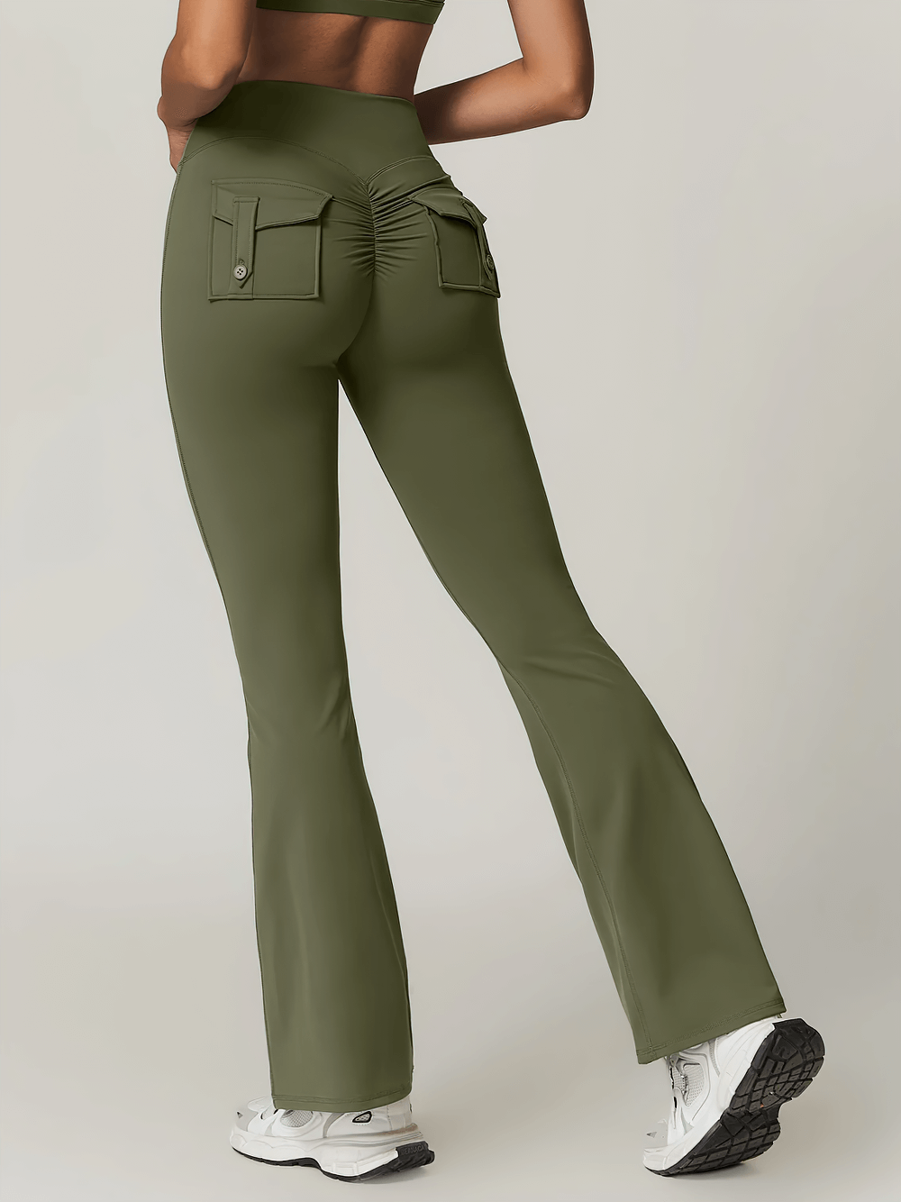 High-waist flare yoga pants with pocket and scrunch detail for gym, yoga, and casual wear in olive color.