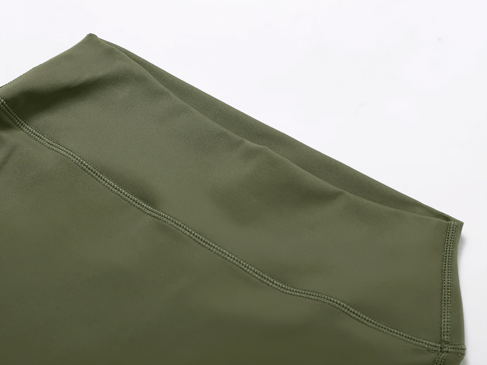 Close-up of green flare yoga pants fabric highlighting high-quality stitching.