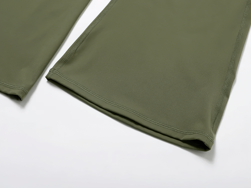 Close-up of green flare yoga pants fabric texture with bell-bottom design. Ideal for yoga and gym, offering style and comfort.