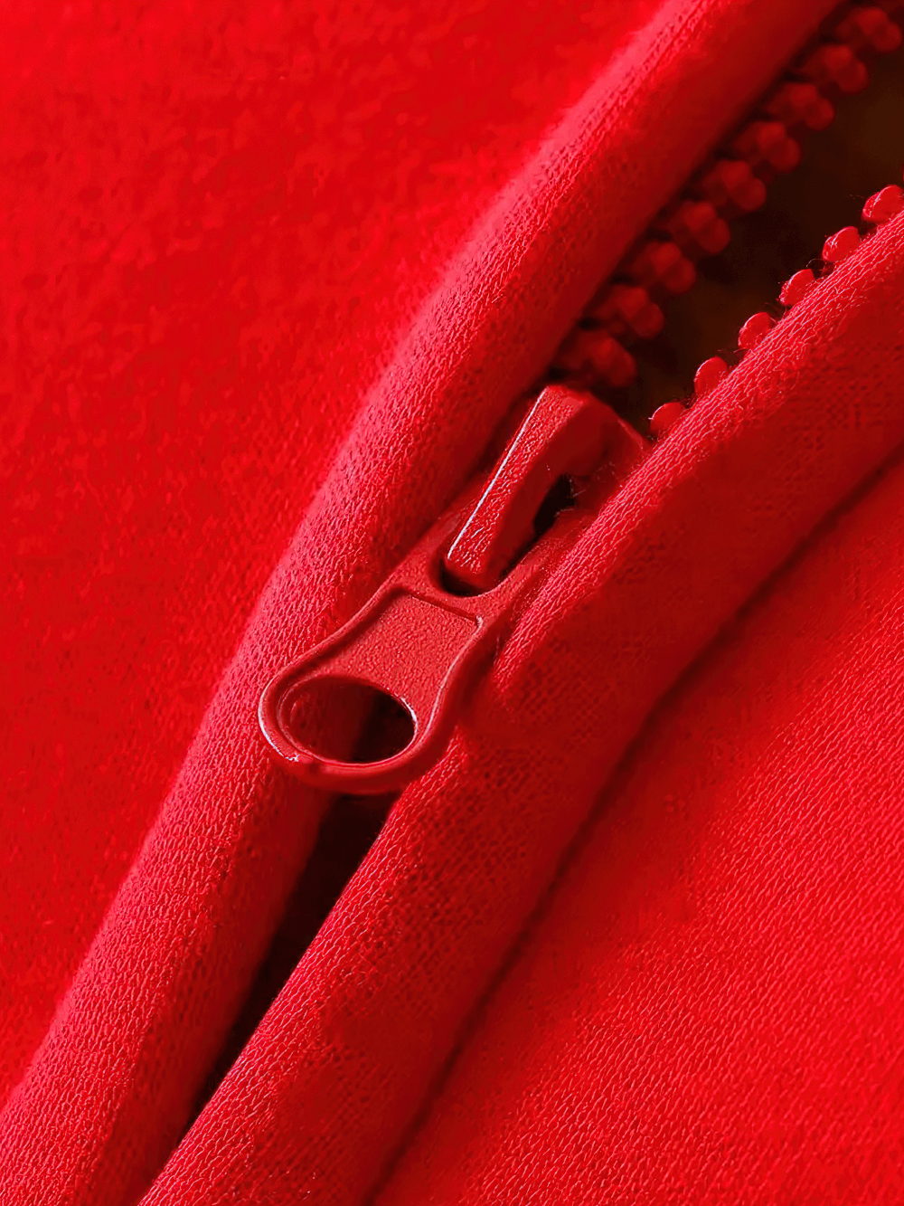 Close-up of red zip on Fleece Lined Zipper Hoodie with Pockets - SF3667, showcasing detailed stitching and cozy fabric texture.