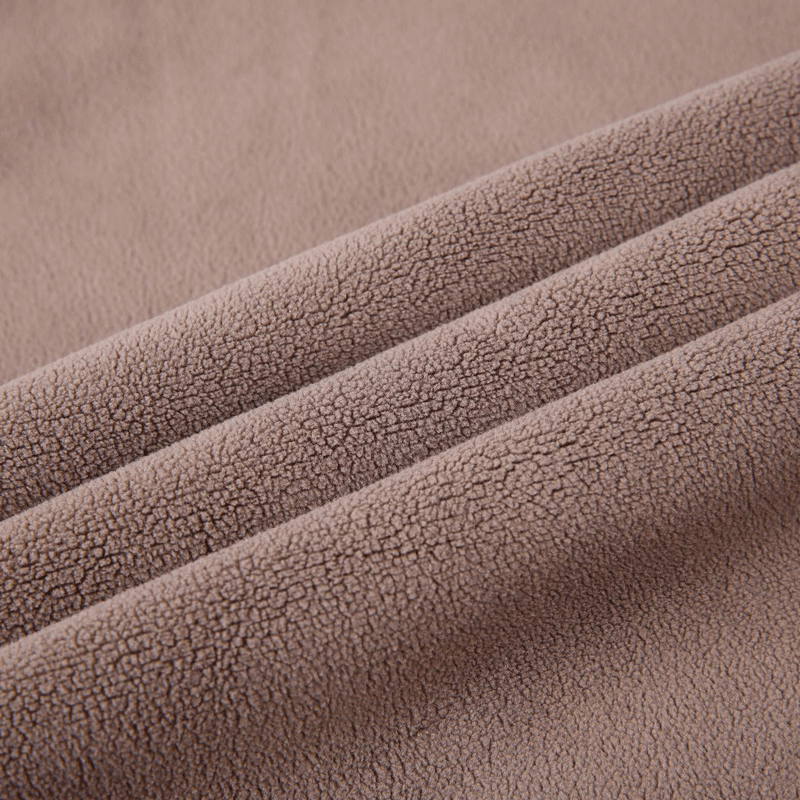Close-up of soft brown fleece fabric texture, highlighting warmth and comfort for men's thermal underwear.