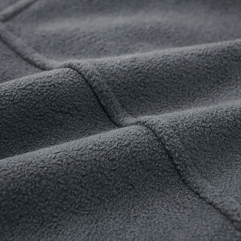 Close-up of soft grey fleece fabric highlighting texture and warmth, ideal for men's thermal hooded jackets.