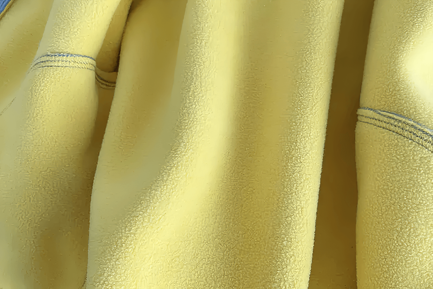 Close-up of yellow fleece fabric detail for warm jacket.