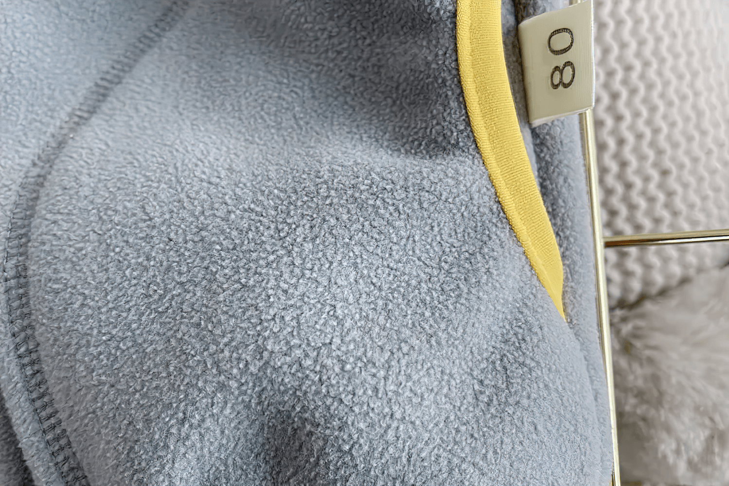 Close-up of Fleece Zip Jacket with Lion Embroidery Design - SF3541 showing soft blue fabric and yellow trim.