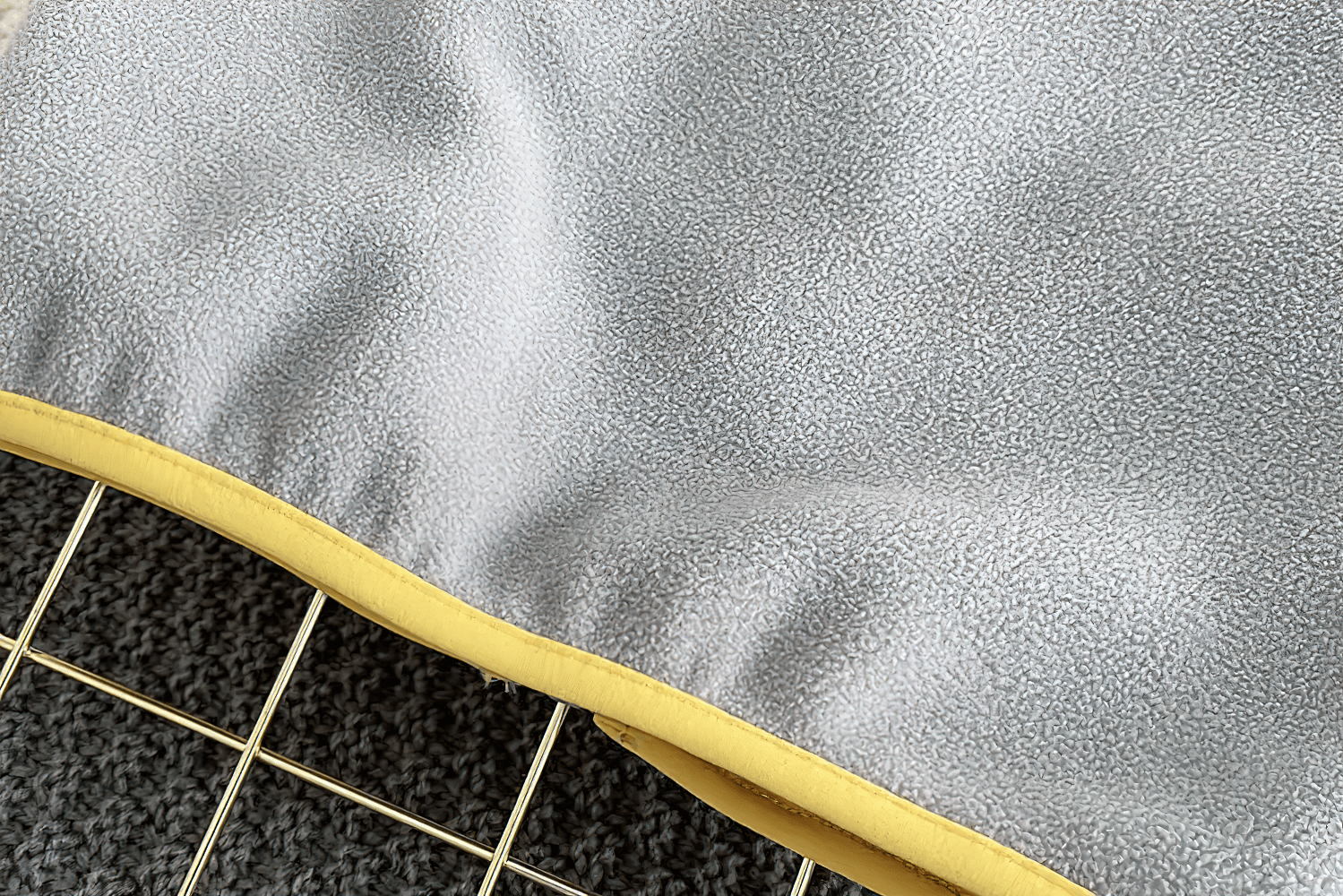 Close-up of gray fleece fabric with yellow trim from the Fleece Zip Jacket with Lion Embroidery Design - SF3541, showcasing texture details.