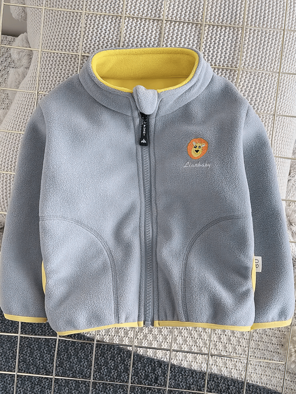 Gray fleece zip jacket with lion embroidery design, SF3541, for kids. Cozy polar fleece outerwear with high collar and full-zip front.